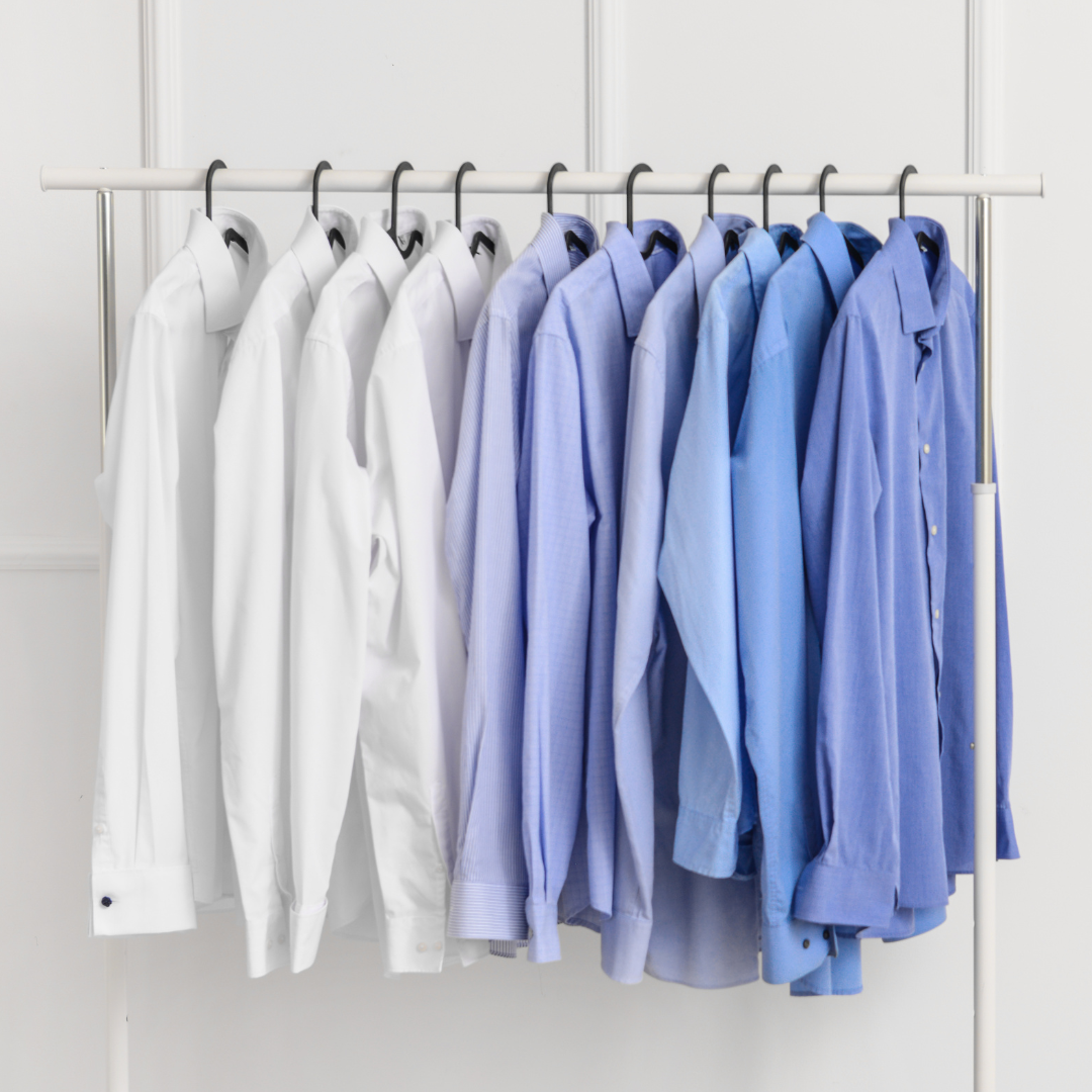 Clean dress shirts hanging on a rack at The Laundry Room in Roxboro, NC